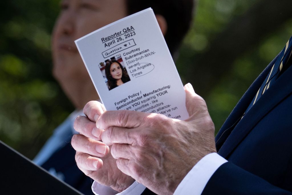 President Biden's hands holding a booklet titled "Reporter Q&A"