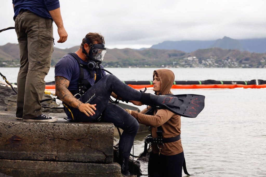 U.S. Navy Sailors with Company 1-3, Mobile Diving and Salvage Unit 1, prepare to detach a fuel hose after completing defueling operations on a downed U.S. Navy P-8A Poseidon in waters just off the runway at Marine Corps Air Station Kaneohe Bay, Marine Corps Base Hawaii, Nov. 26, 2023. The successful defueling of the downed P-8A was critical to the execution of the aircraft salvage plan. (U.S. Marine Corps photo by Sgt. Brandon Aultman)