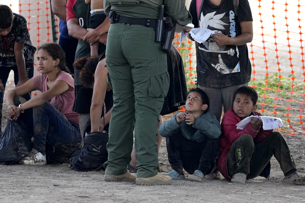 Migrants who crossed into the U.S. from Mexico wait to be processed by U.S. Border Patrol agents, Thursday, Sept. 21, 2023, in Eagle Pass, Texas. (AP Photo/Eric Gay)