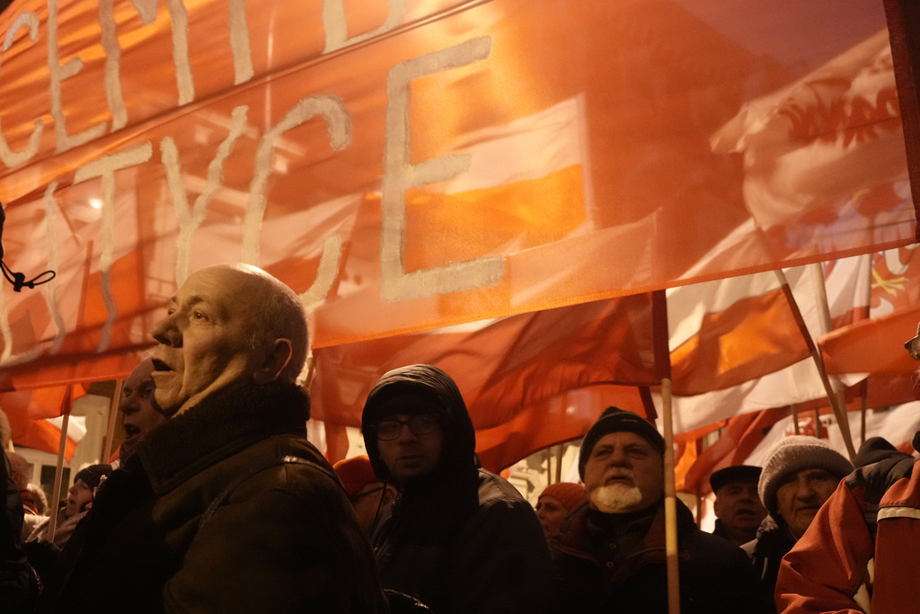 Supporters of right-wing Law and Justice party protest before the parliament building in Warsaw, Poland, on Thursday, Jan. 11, 2024. Law and Justice, frustrated over its recent loss of power, urged its supporters to protest moves by the new pro-European Union government to take control of state media. It also said it was protesting the arrests Tuesday of two senior members of Law and Justice, former Interior Minister Mariusz Kaminski and his former deputy, Maciej Wasik. (AP Photo/Czarek Sokolowski)