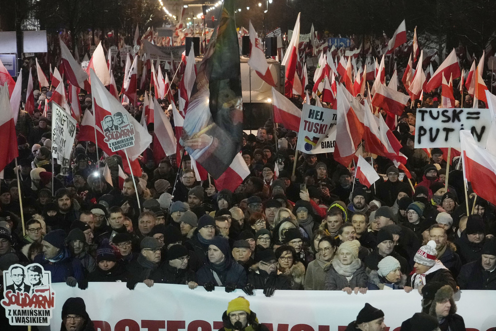 Supporters of right-wing Law and Justice party that lost power in the October parliamentary elections protest the moves by the new pro-European Union government which has taken control of state media, in front of the parliament building in Warsaw, Poland, on Thursday, Jan 11, 2024. Law and Justice, frustrated over the loss of power is seeking to undermine the actions of the new government of Prime Minister Donald Tusk. (AP Photo/Czarek Sokolowski)