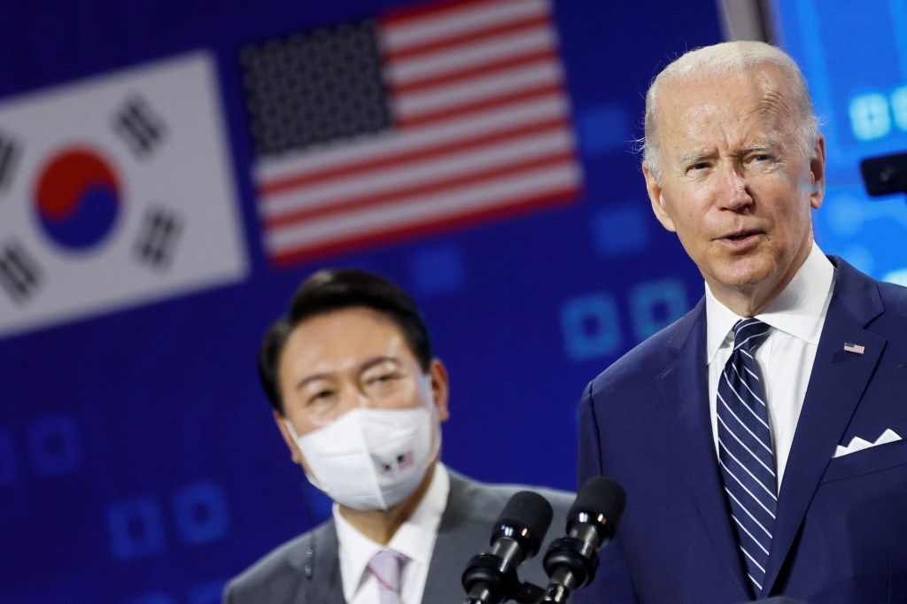 FILE PHOTO: South Korean President Yoon Suk-yeol looks on as U.S. President Joe Biden delivers remarks during a visit to a semiconductor factory at the Samsung Electronics Pyeongtaek Campus in Pyeongtaek, South Korea, May 20, 2022. REUTERS/Jonathan Ernst/File Photo