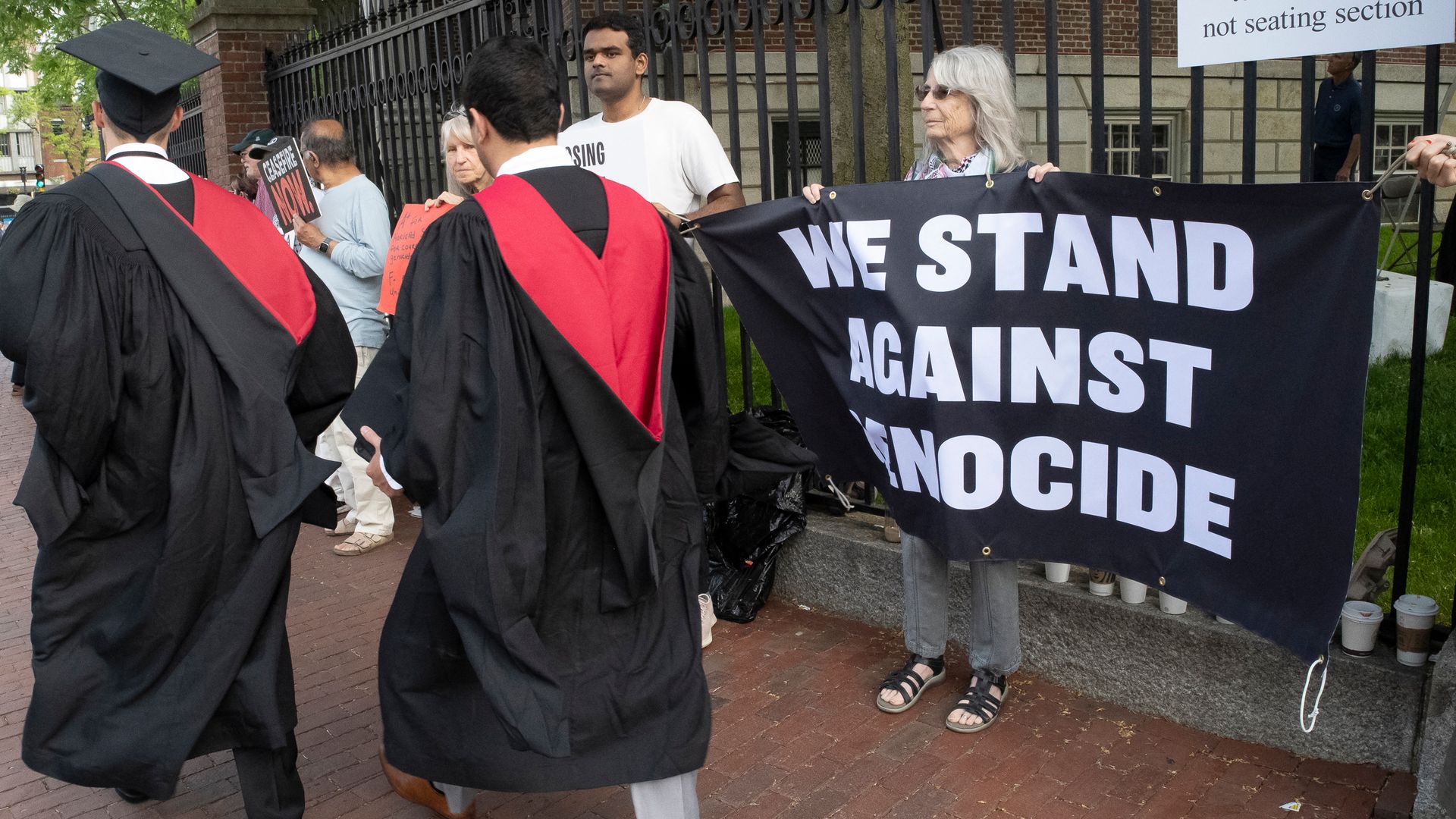 Hundreds of graduates walked out of Harvard’s commencement ceremony in protest after 13 students were barred from the ceremony.