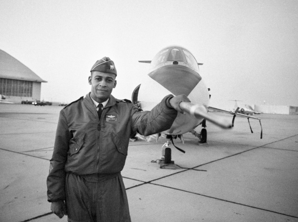 Captain Ed Dwight stands in front of the F-104 jet fighter, which he flies today seem mighty tame when he starts training in specially-equipped, high-performance jets that will soar to the edge of space.  (Photo by Bettmann Archive/Getty Images)