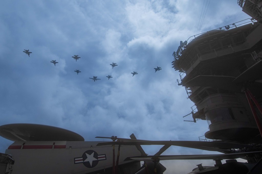 240802-N-NA571-2121 PACIFIC OCEAN (Aug. 2, 2024) Carrier Air Wing 9 fly in formation over the Nimitz-class aircraft carrier USS Abraham Lincoln (CVN 72). Abraham Lincoln, flagship of Carrier Strike Group Three, is underway conducting routine operations in the U.S. 7th Fleet area of operations. U.S. 7th Fleet is the U.S. Navy’s largest forward-deployed numbered fleet, and routinely interacts and operates with allies and partners in preserving a free and open Indo-Pacific region. (U.S. Navy photo by Mass Communication Specialist 3rd Class Valerie Morrison)