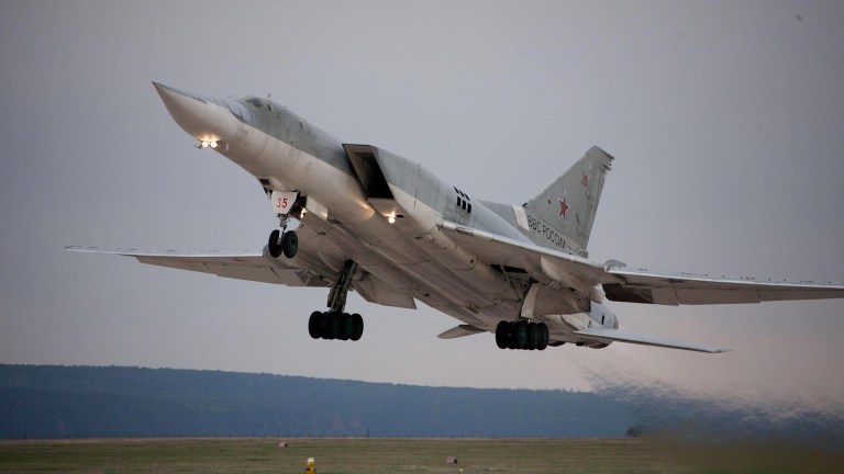 A Russian Tu-22M3 bomber crashed in Siberia after catching fire mid-air, killing one crew member and prompting investigations.