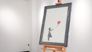 A painting by the British street artist Banksy was stolen from the Grove Gallery in London, with two charged in the raid.