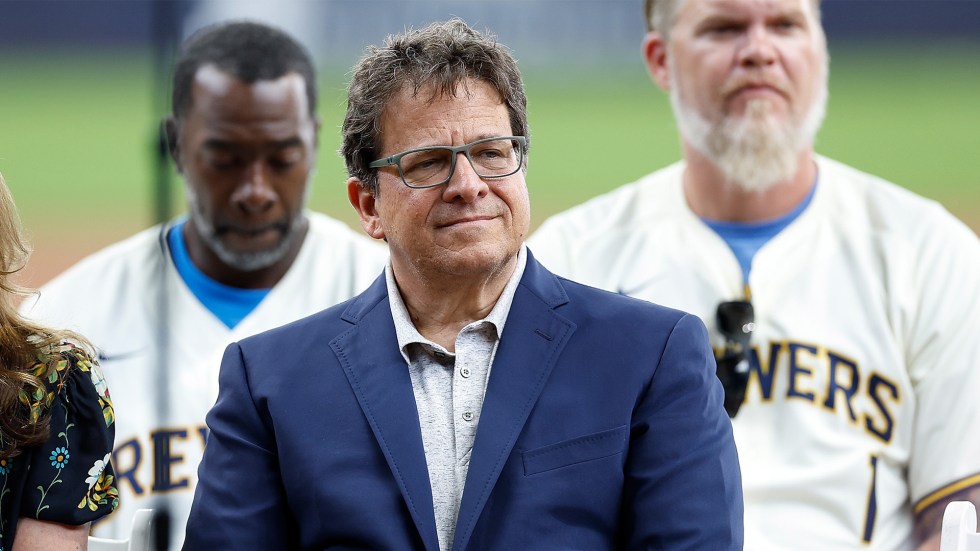 Milwaukee Brewers owner Mark Attanasio is entangled in a legal dispute over the removal of sand from a public beach near his Malibu property.