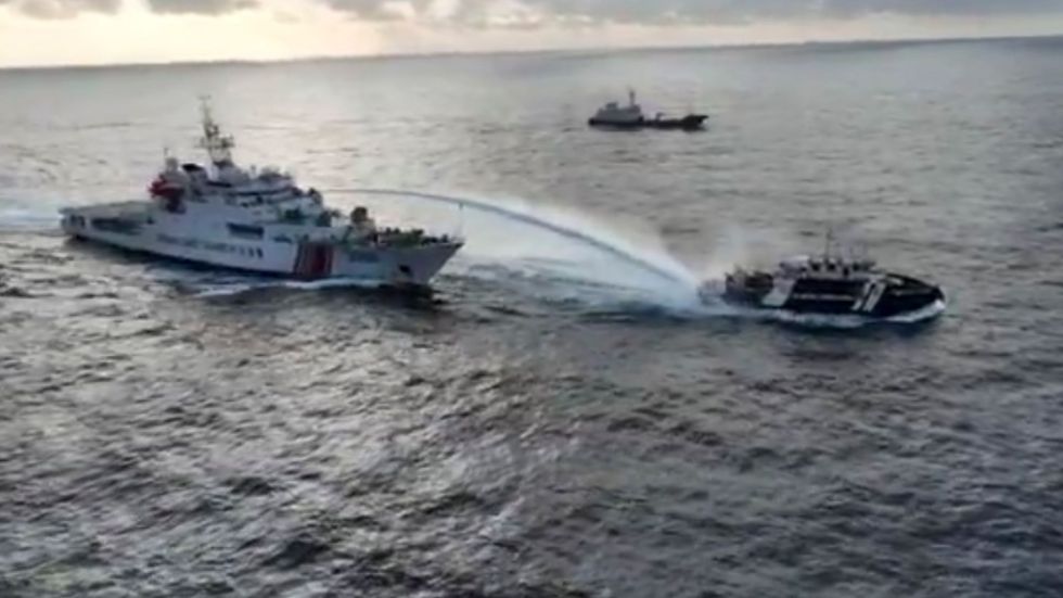 The Philippines says the Chinese coast guard fired water cannons and hit one of its ships in the South China Sea on Wednesday.