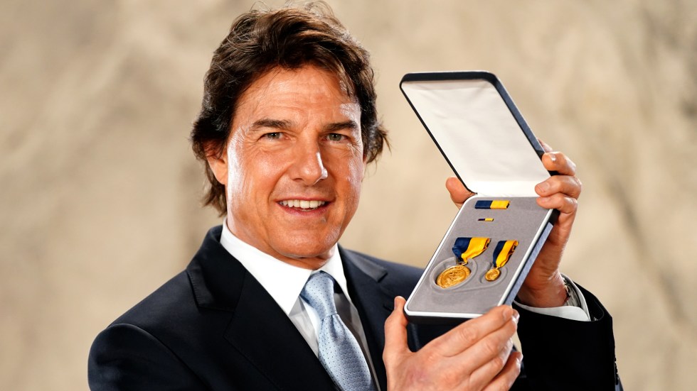 Tom Cruise receives Navy's top civilian honor for contributions to Navy and Marine Corps through film industry.