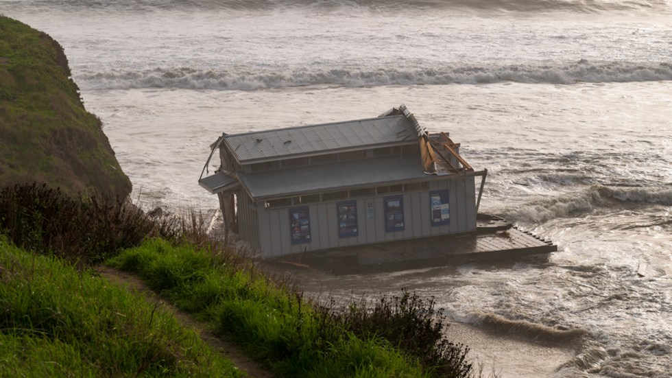 Santa Cruz Pier partially collapses in California storm surge, three rescued after falling into ocean amid construction repairs.