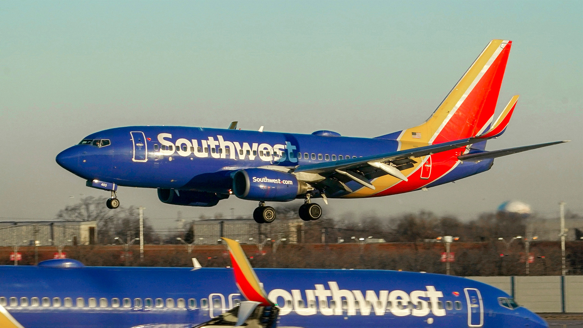 The DOT sues Southwest and fines Frontier for chronic flight delays. It's an effort to hold airlines liable for unrealistic scheduling.